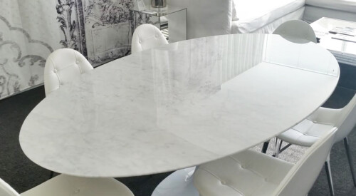 An oval marble table with a gloss protection film by TuffSkin Surface Protection.